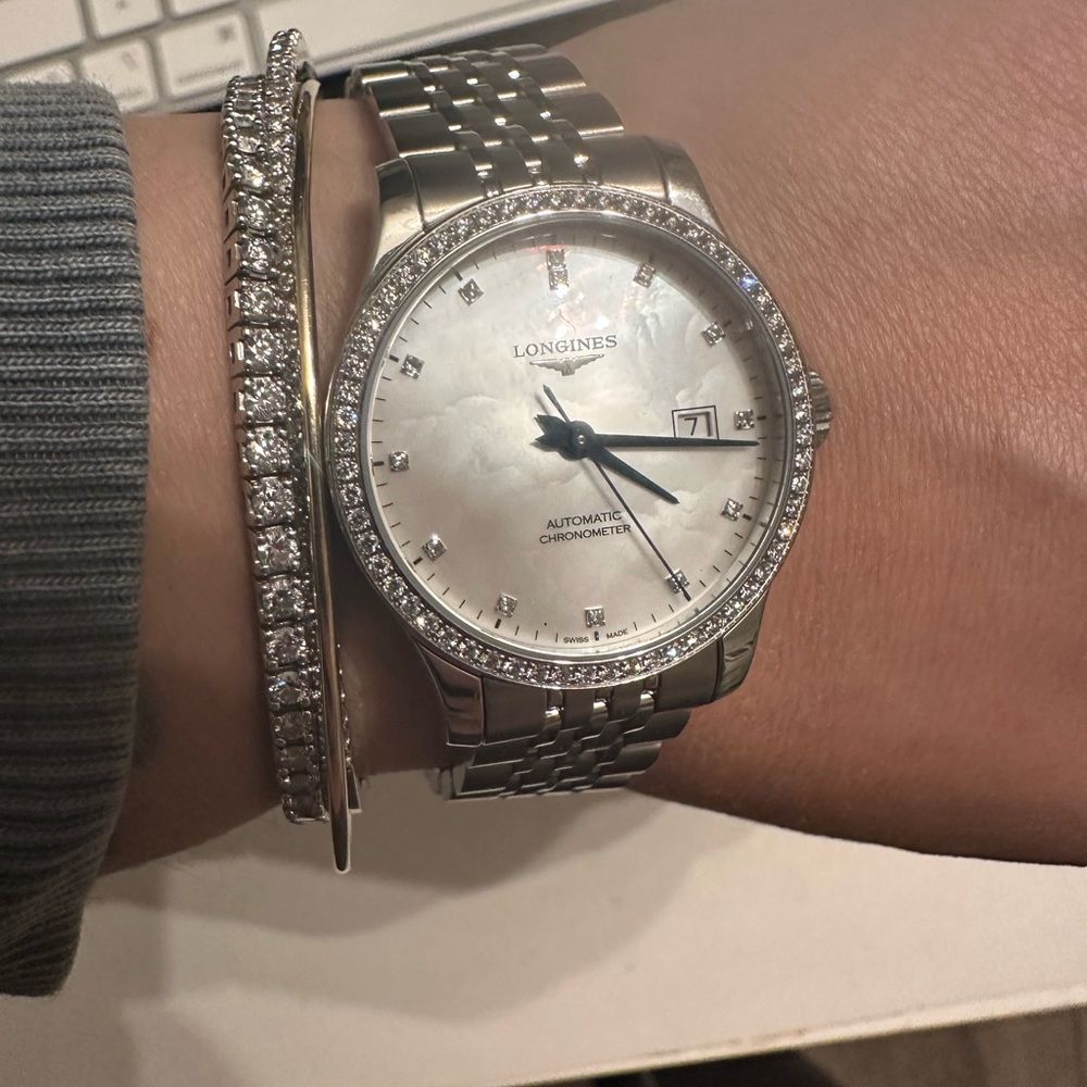 Longines ladies mother of peal diamond stainless steel watch.